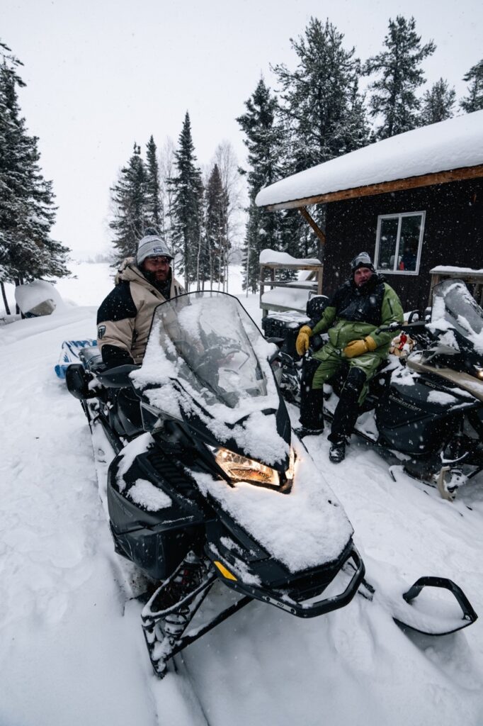 Snowmobiles at the Kamuchawie Lake Lodge preparing to go ice fishing