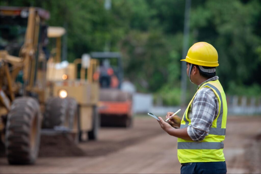 Construction worker in uniform managing a project in northern Manitoba, representing demand for extended stay accommodations near Flin Flon.