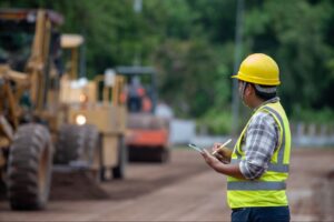 Construction worker in uniform managing a project in northern Manitoba, representing demand for extended stay accommodations near Flin Flon.