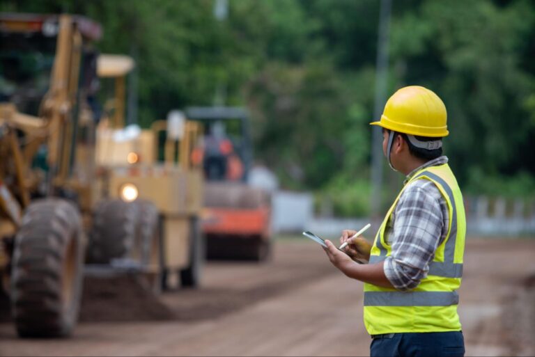 Construction worker in uniform managing a project in northern Manitoba, representing demand for extended stay accommodations near Flin Flon.