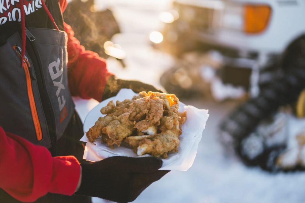 Close-up of outdoor meal preparation on frozen lake