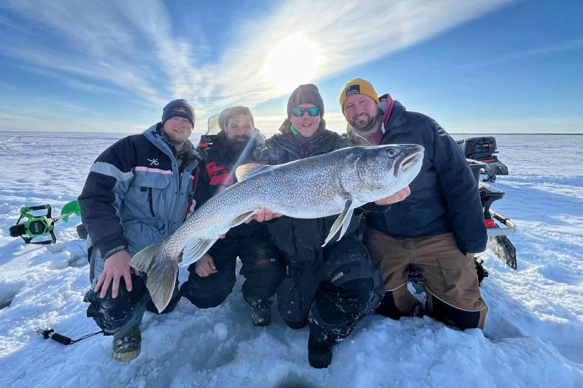 group of friends ice fishing in Manitoba