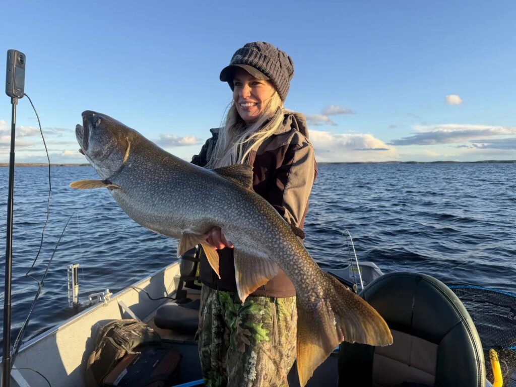 Nicole Stone holding a trophy lake trout at the Kamuchawie Lake fly-in outpost, Bakers Narrows Lodge