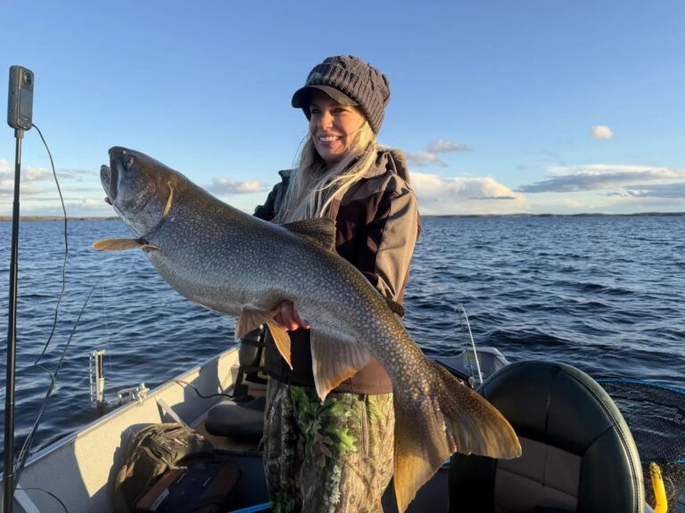Nicole Stone holding a trophy lake trout at the Kamuchawie Lake fly-in outpost, Bakers Narrows Lodge