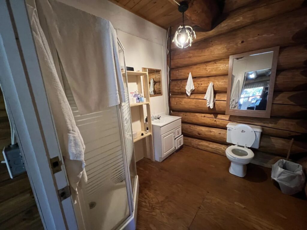 Full bathroom with shower inside the Kamuchawie Lake outpost cabin