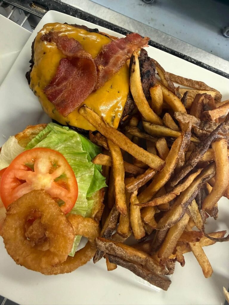 Bacon cheeseburger with onion ring and fresh-cut fries from Bakers Narrows Lodge