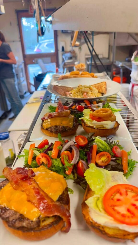 Bacon cheeseburgers and garden salads ready to serve in the Bakers Narrows Lodge kitchen