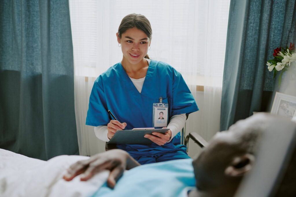 Travel nurse in scrubs caring for a patient, looking for housing near Flin Flon